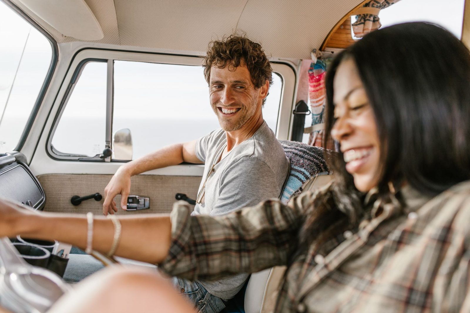 A couple on a road trip in a vintage camper van