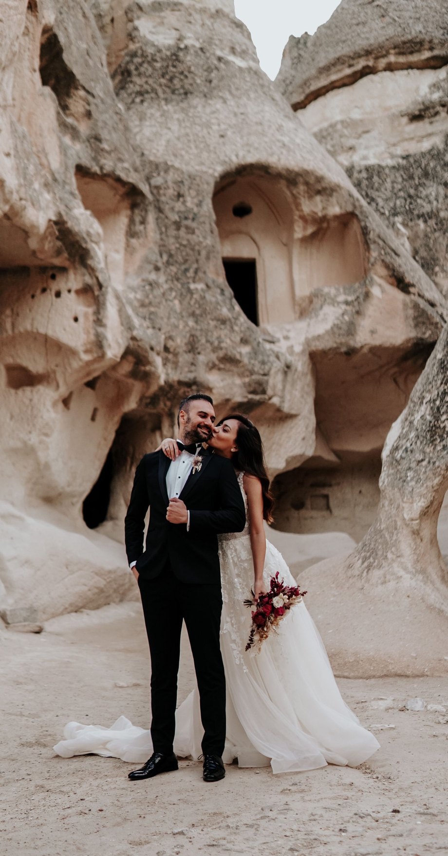 A bride and groom among the rock formations of Cappadocia, Turkey