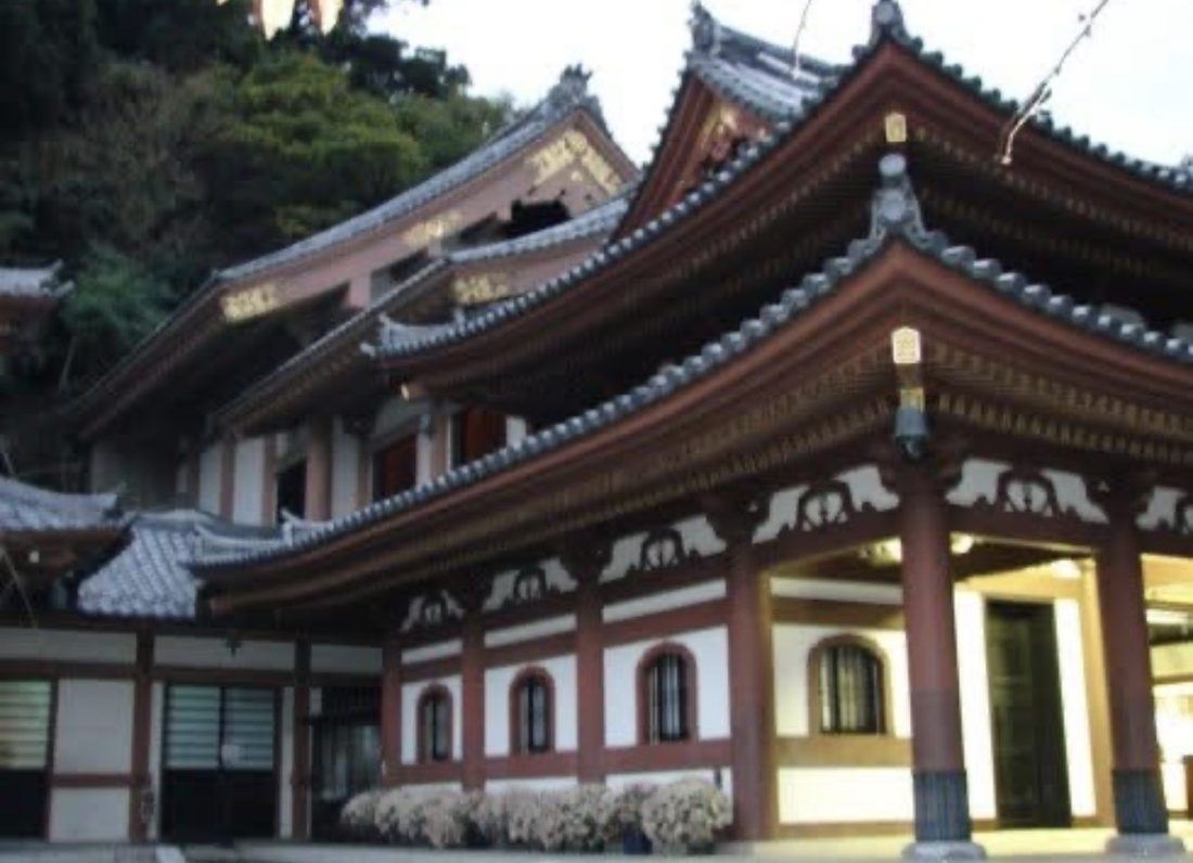 A hillside Buddhist temple in Kamakura, Japan with sweeping tiled roofs