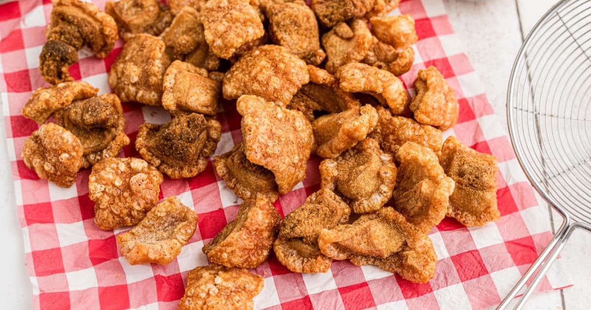 Fried pork cracklins, known as gratons, on red checked paper