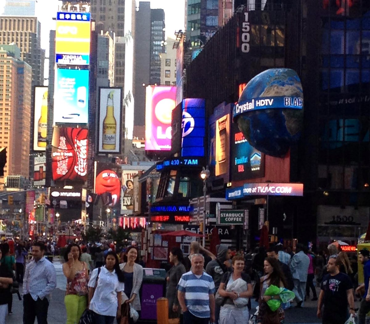 Crowds and lit billboards in Times Square, New York City