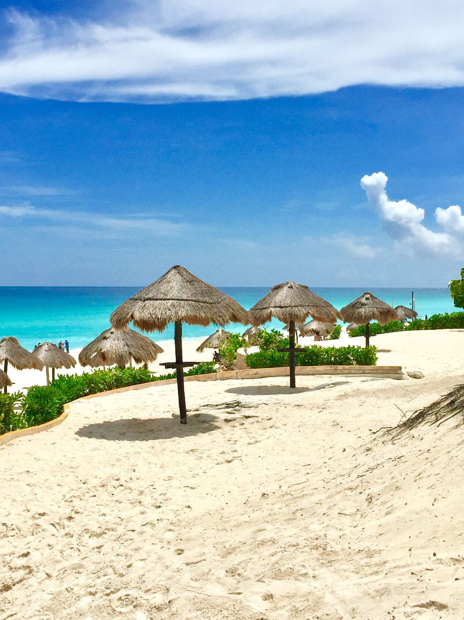Palapas on a white sand beach on the Caribbean coast of Mexico