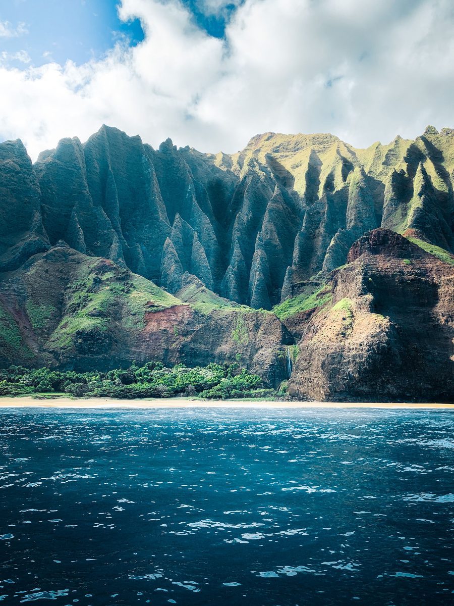 The Na Pali Coast cliffs rising above the ocean on Kauai, Hawaii